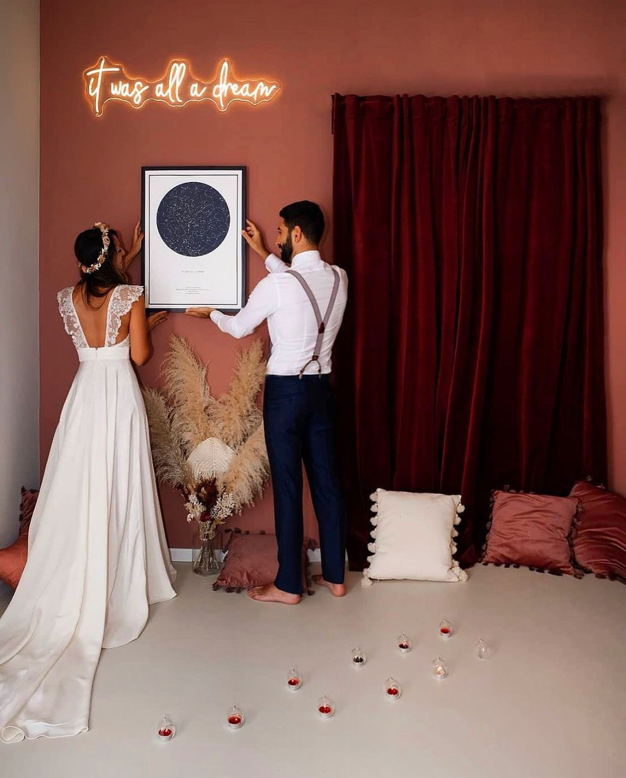 A couple hanging their star map on their wedding day.