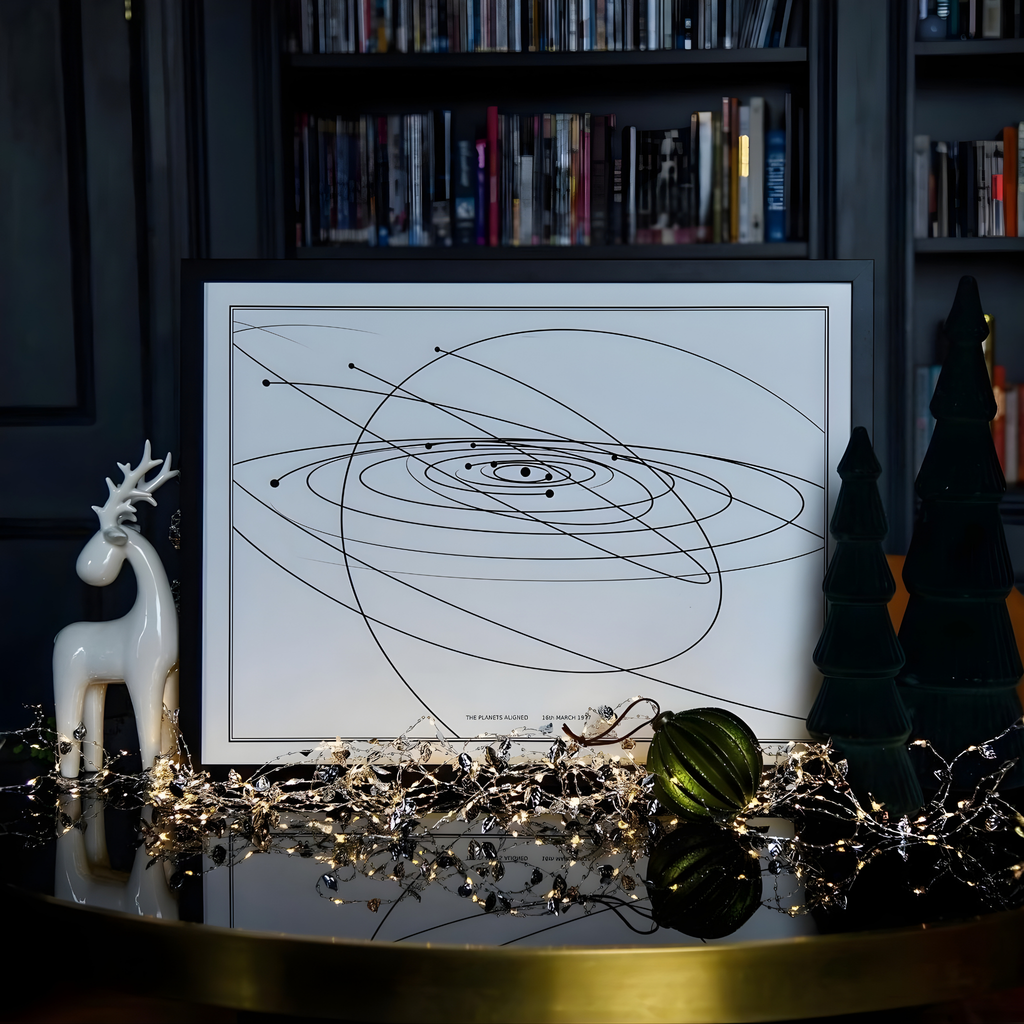 Framed Solar map in front of a black wooden bookcase