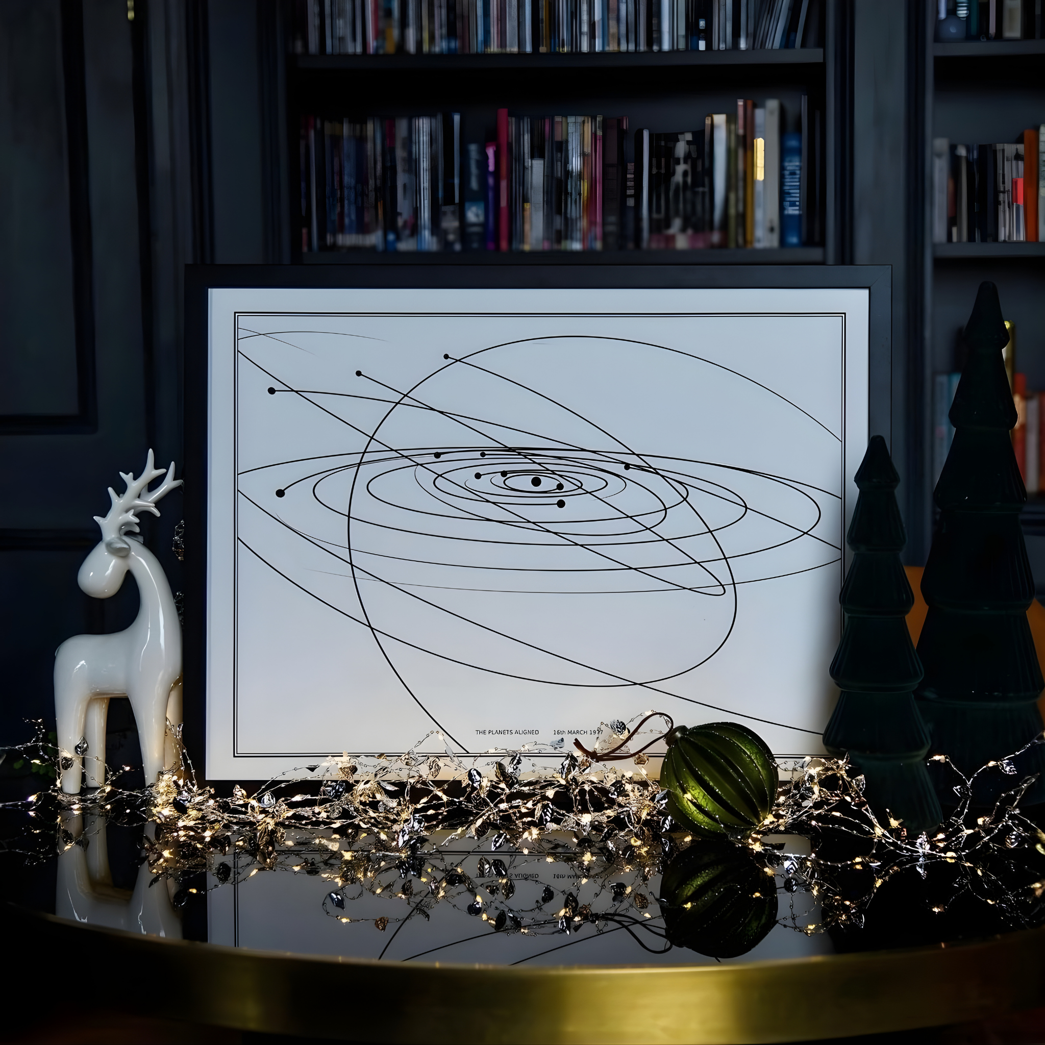 Framed Solar map in front of a black wooden bookcase