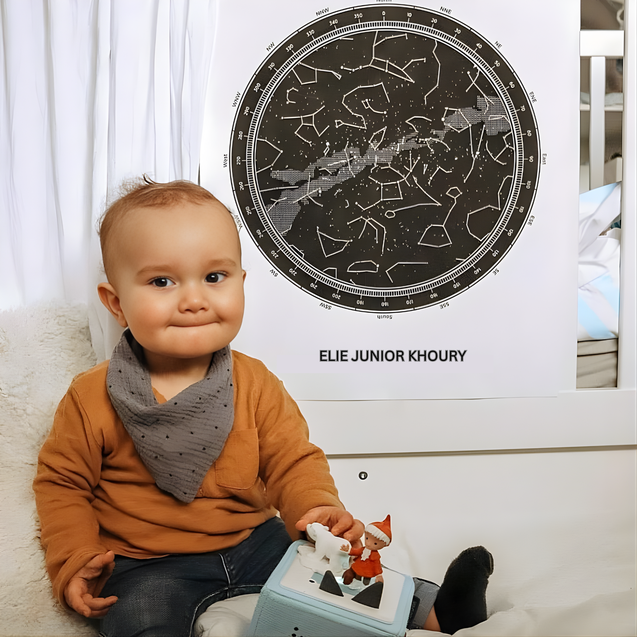 A young boy posing in front of his star map, celebrating his first tooth.