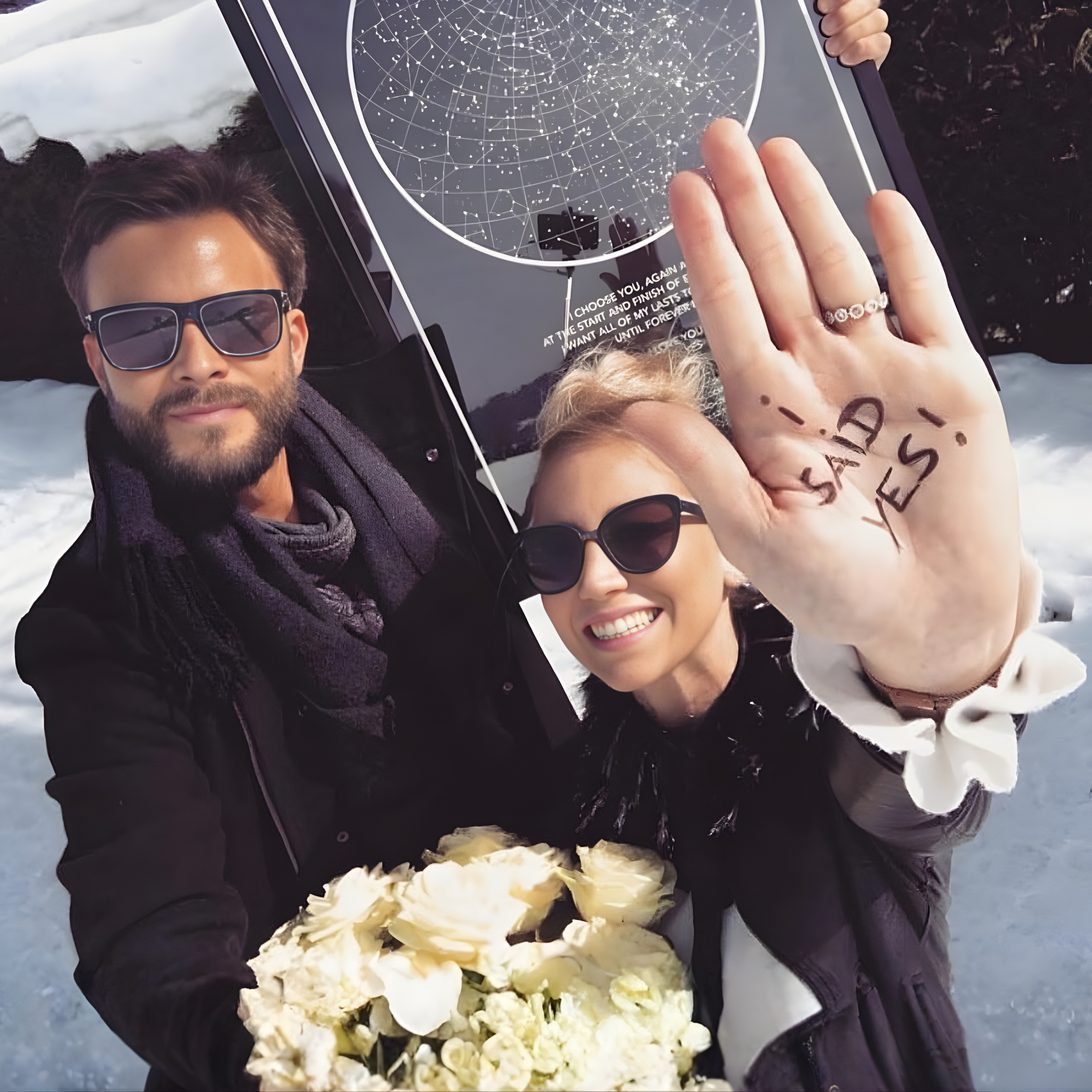 A couple posing on their proposal day with their star map
