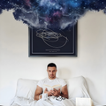 man sitting in bed reading a book with a solar map behind him expanding his imagination.